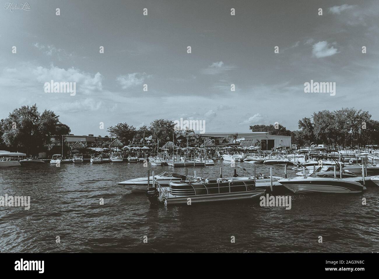Gray scale shot of some boats floating on a lake Stock Photo - Alamy