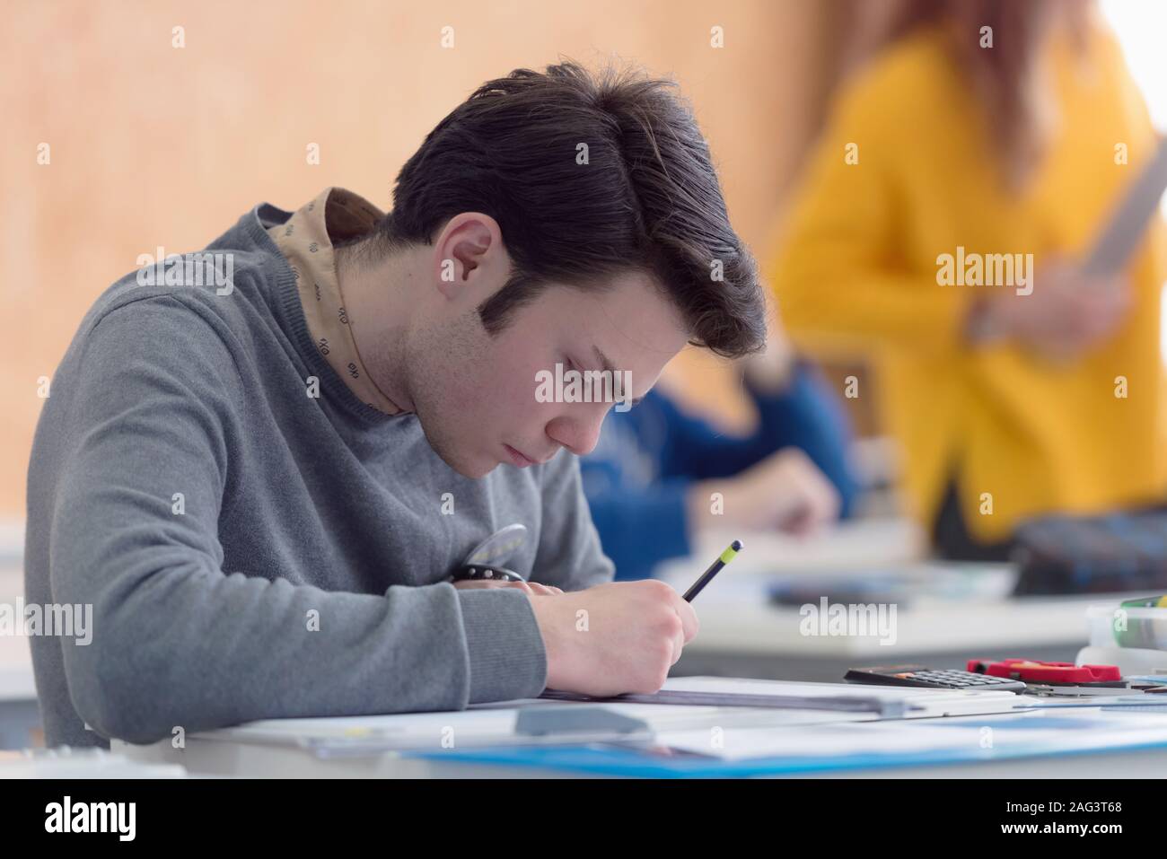 Male university architecture student working on practice lessons. Looking for solution during class. Stock Photo