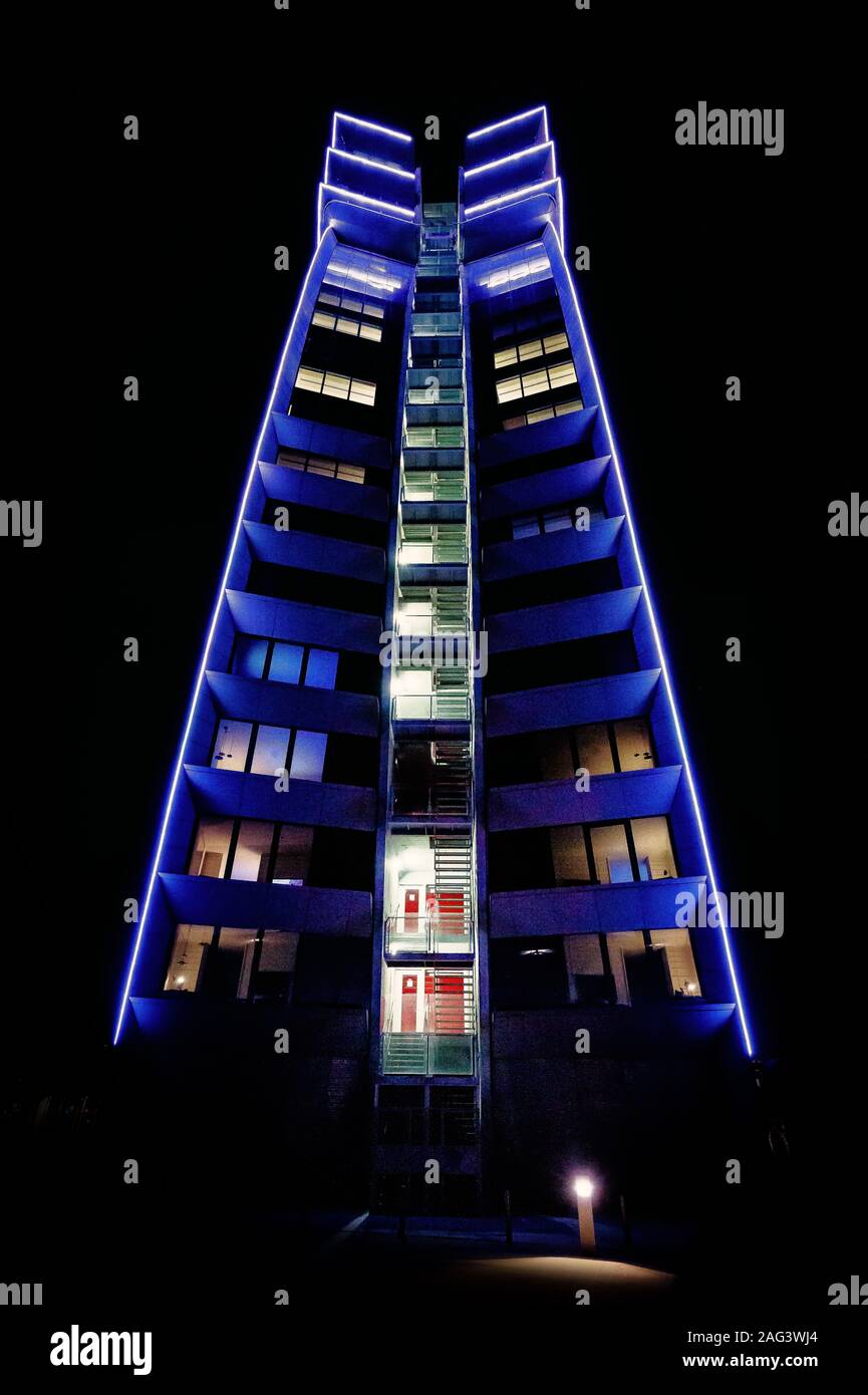Vertical shot of a building with blue lights at night Stock Photo