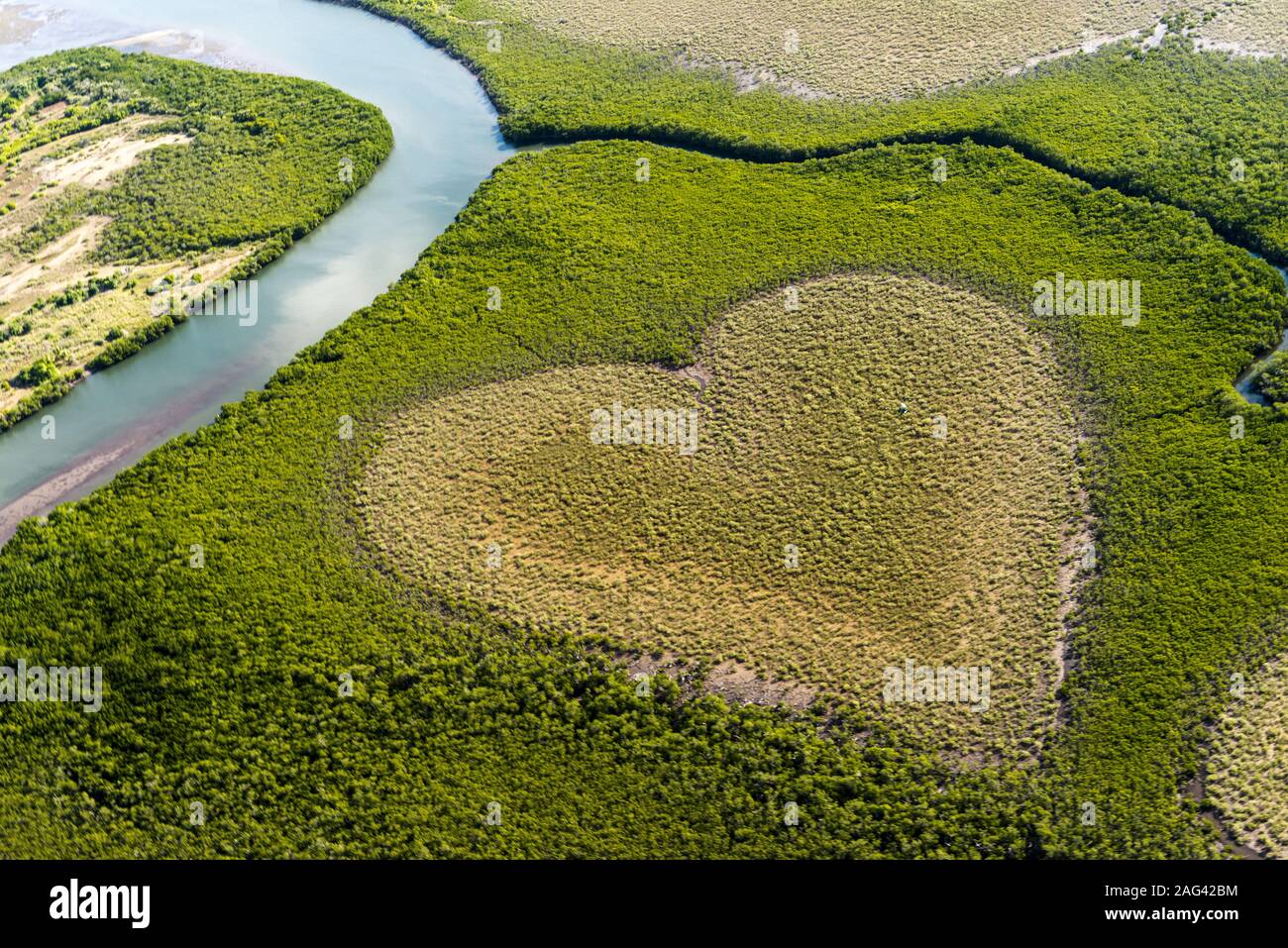 Beautiful high angle shot of a green field with a heart shape and a river  on the left Stock Photo - Alamy