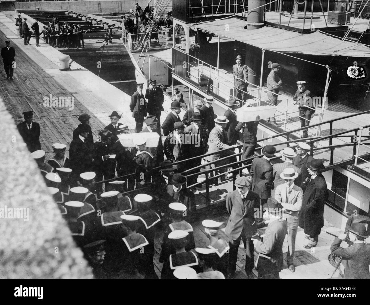 Sailors taking children in coffins from the Lady Grey at Quebec following the sinking of the RMS Empress of Ireland in May 1914. Stock Photo