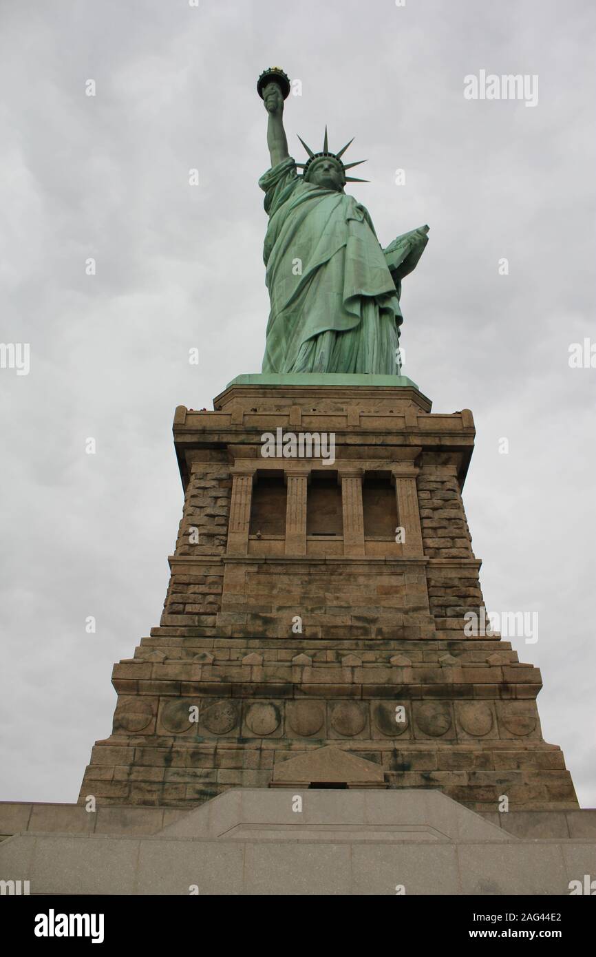 Vertical low angle shot of The Statue of Liberty in New York City with ...