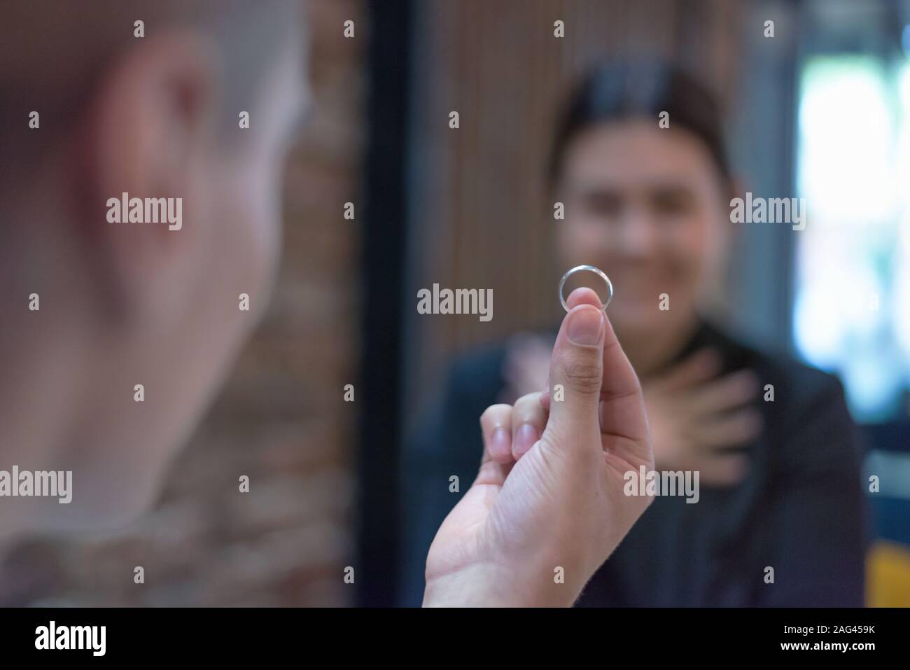 Giving of wedding ring. Man giving an engagement ring to his girlfriend