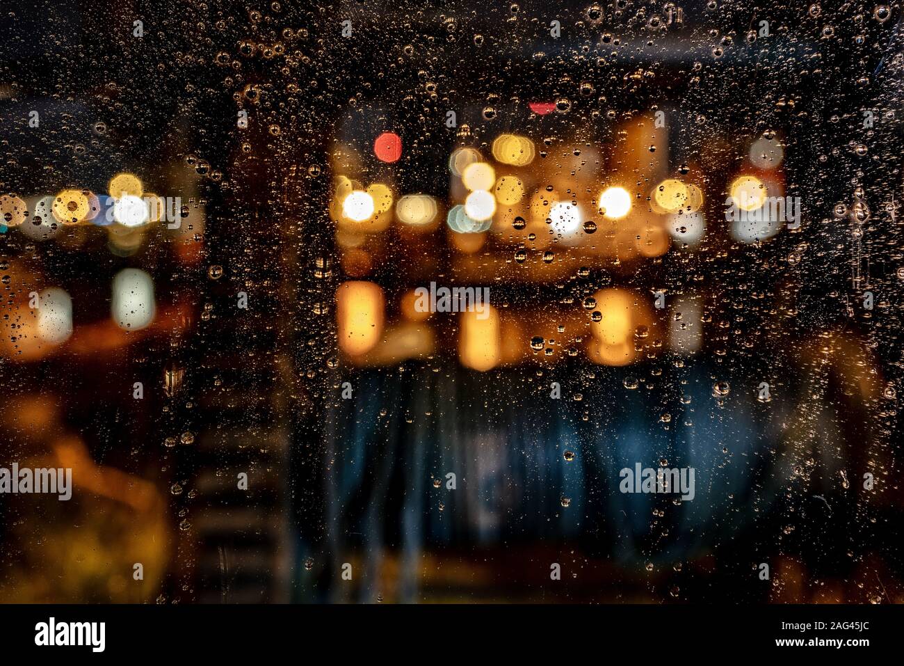Beautiful shot of water drops on a window during a rainy night ...