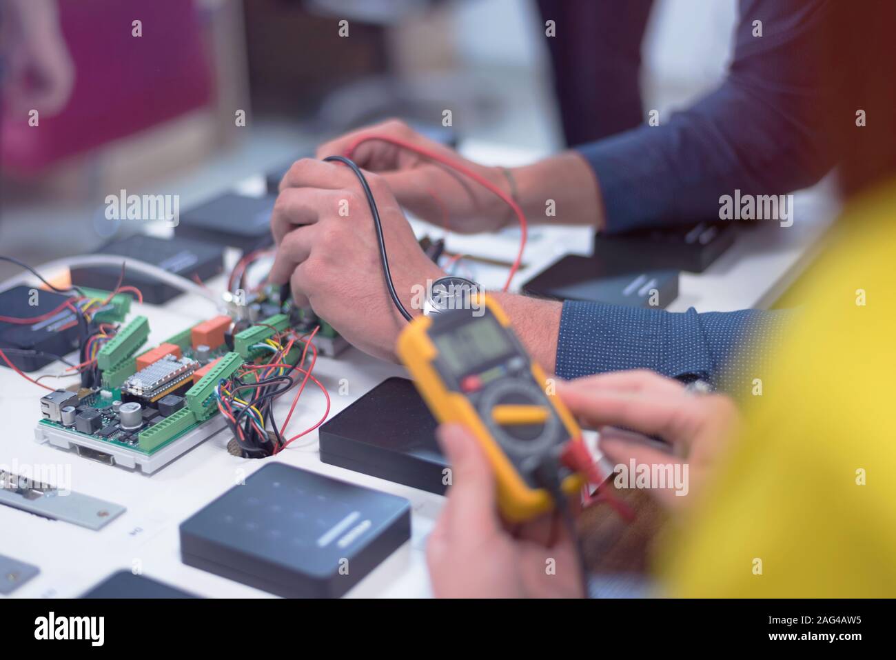 Two young handsome engineers working on electronics components.Tech ...