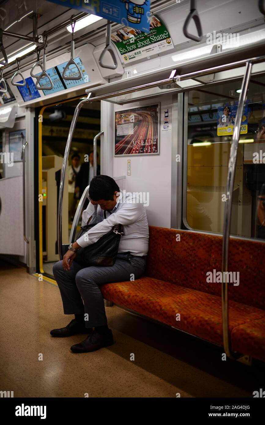 Tired passenger in subway, Tokyo, Japan Stock Photo