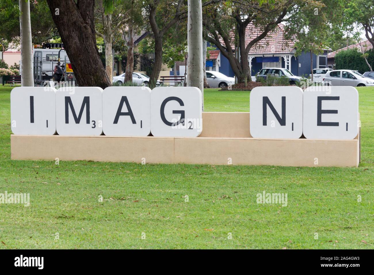 Large scrabble letters forming the word Imagine in a park, Sydney,Australia Stock Photo