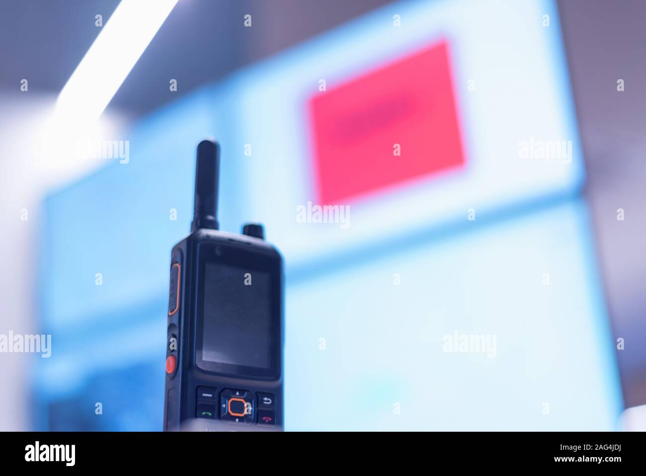 Security guard monitoring modern CCTV cameras in surveillance room