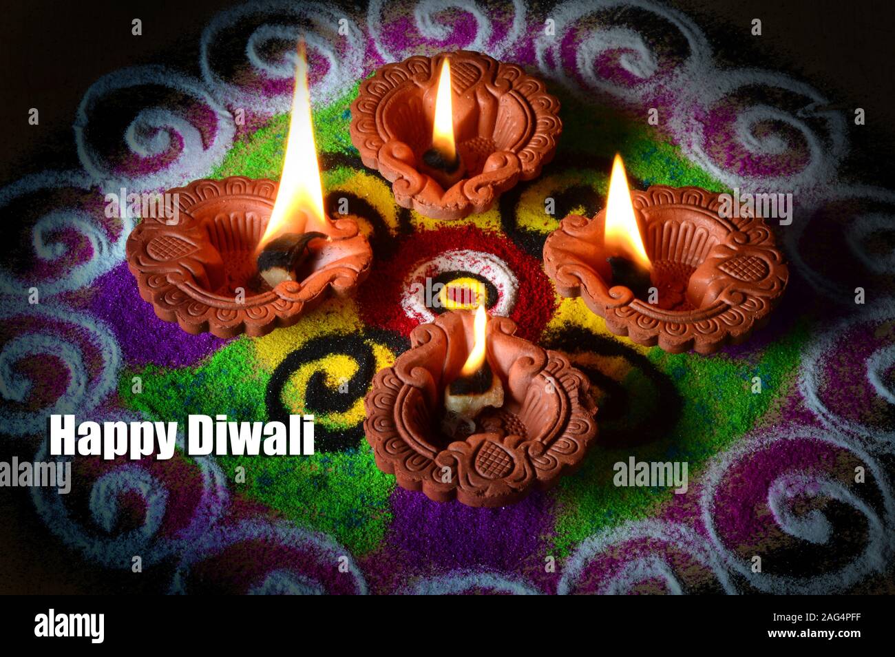 Clay diya lamps lit during diwali celebration, Rangoli in background Stock  Photo - Alamy