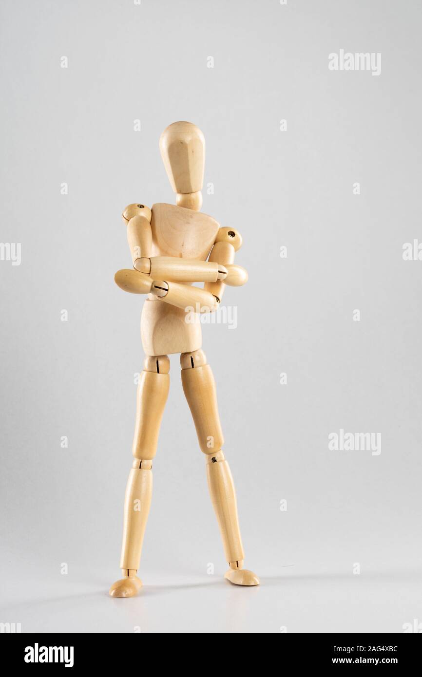yellow wooden mannequin poses and gestures with his hands on a blue  background - Stock Image - Everypixel