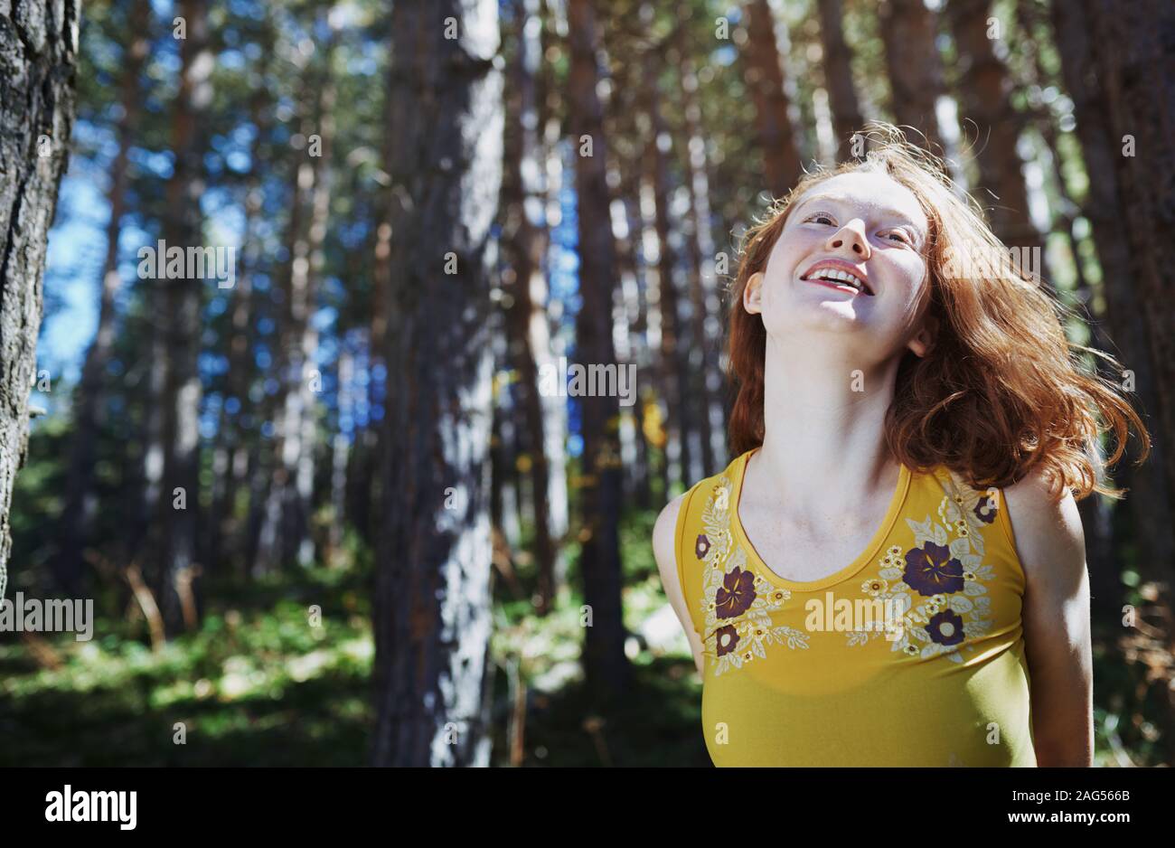 Redhead woman having fun in the wild forest Stock Photo
