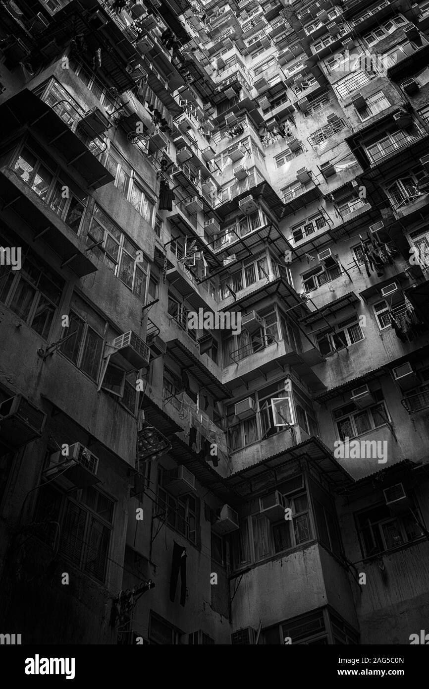 Low angle vertical shot of big apartment wit balconies in black and white Stock Photo