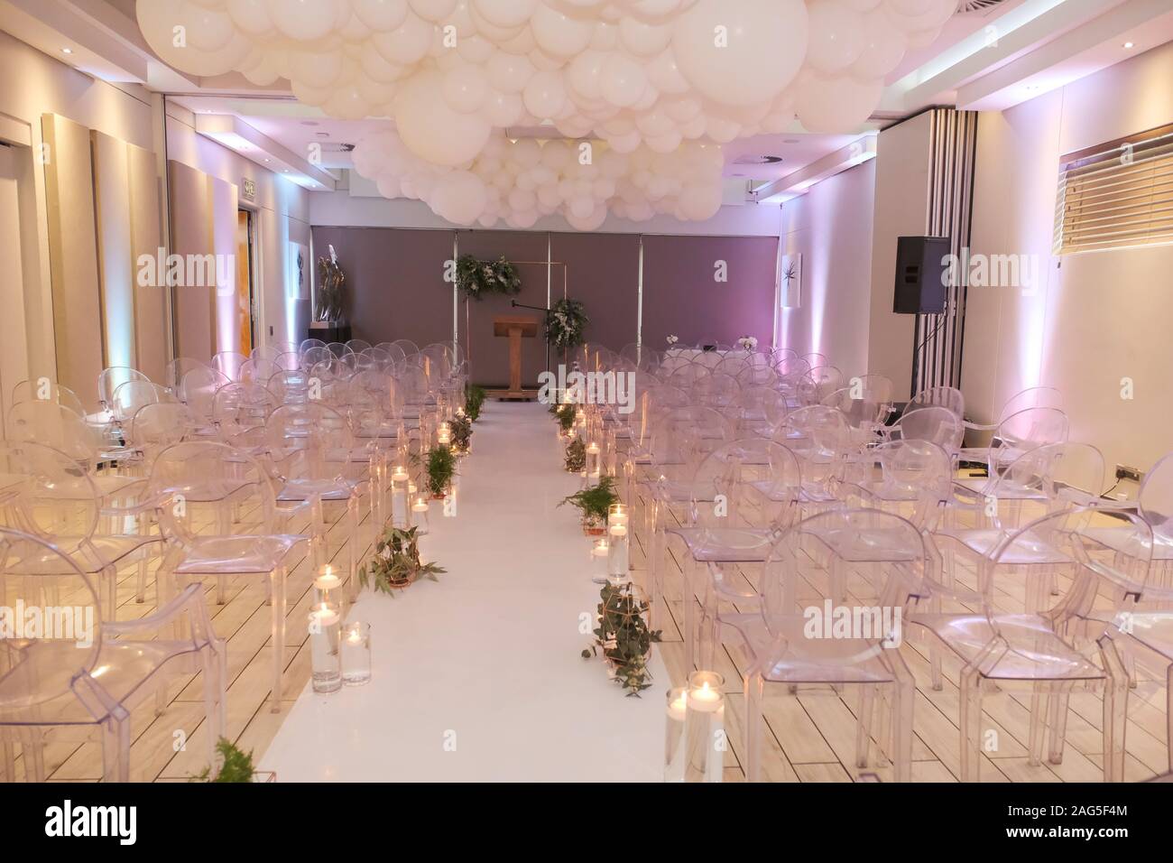 A Wedding Aisle With Empty Chairs Decorated With Candles And