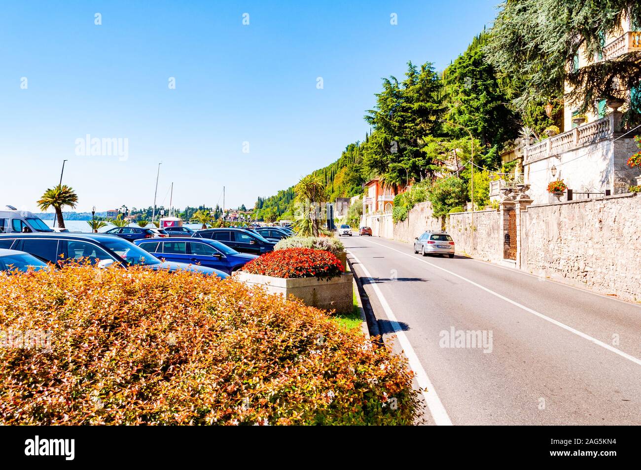 Toscolano Maderno, Lombardy, Italy - September 12, 2019: Scenic panoramic beltway road around lake Garda with medieval architecture buildings and rich Stock Photo