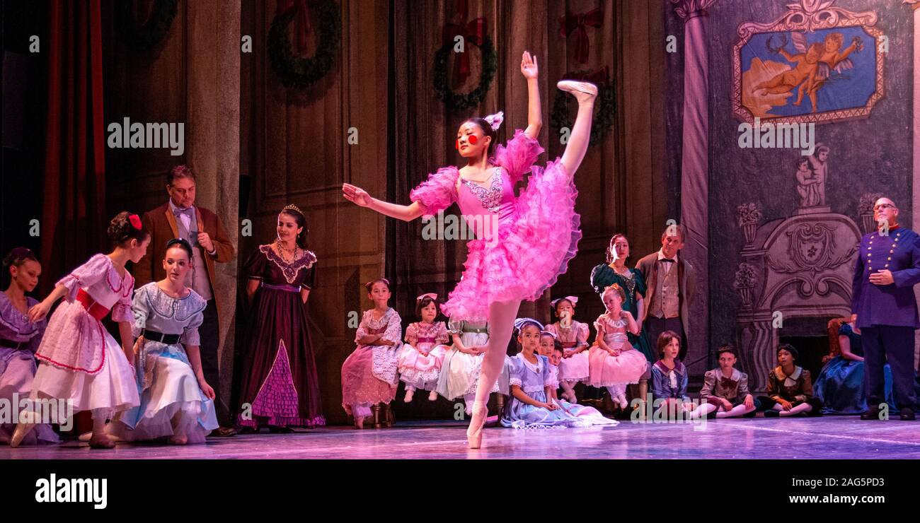 Dancing Doll dancer performs difficult choreography on pointe in the party scene during rehearsal of The Nutcracker, a popular Christmas ballet. Stock Photo