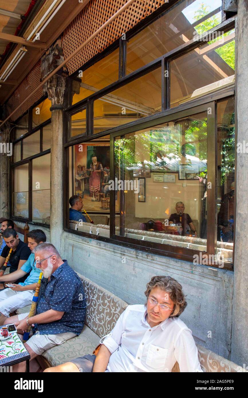 Istanbul, Turkey - July 14, 2015: People resting and chating in Corlulu Ali Pasa Medresa on July 14, 2015. Corlulu Ali Pasa Medresa  is historical fam Stock Photo