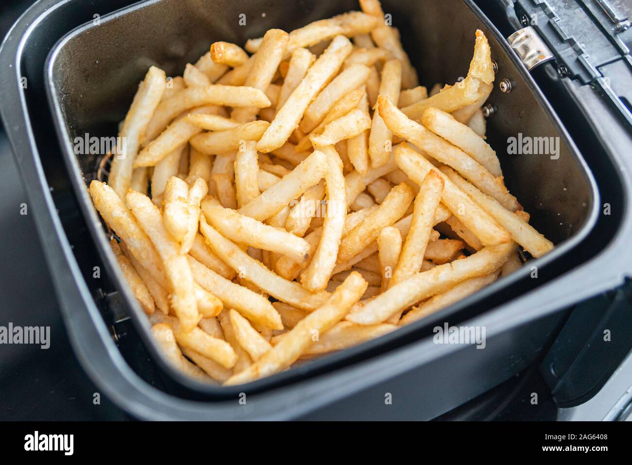 Frech Fries in Deep frier ready to eat Stock Photo