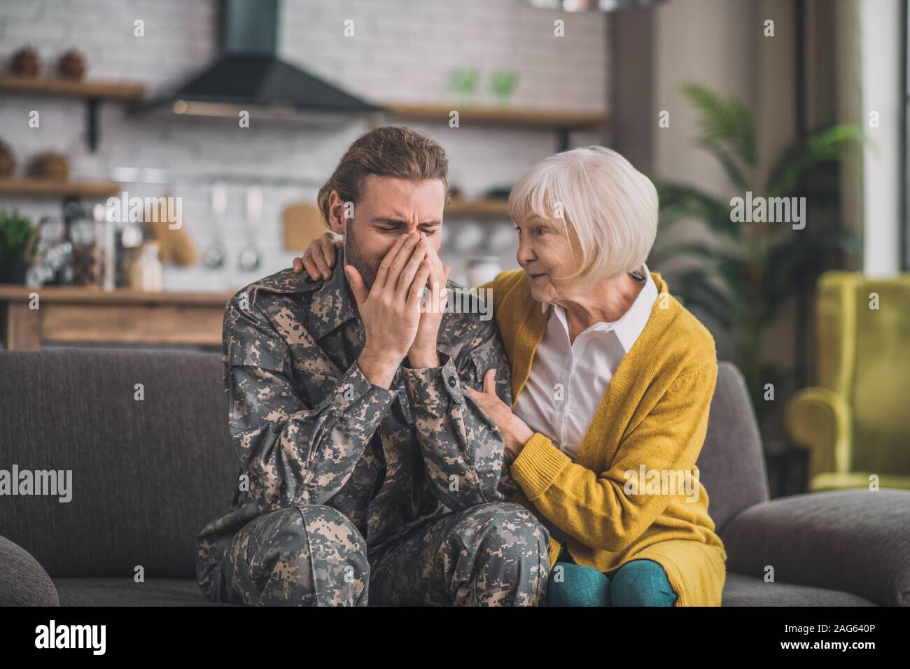Psychological problems. Young handsome man in camouflage looking stressed Stock Photo