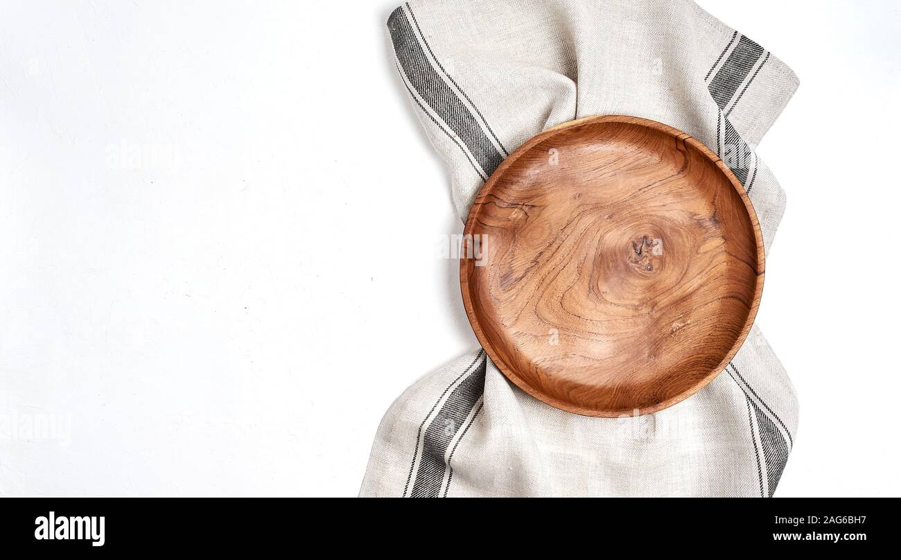Tablecloth, wooden plate on blue table background Stock Photo