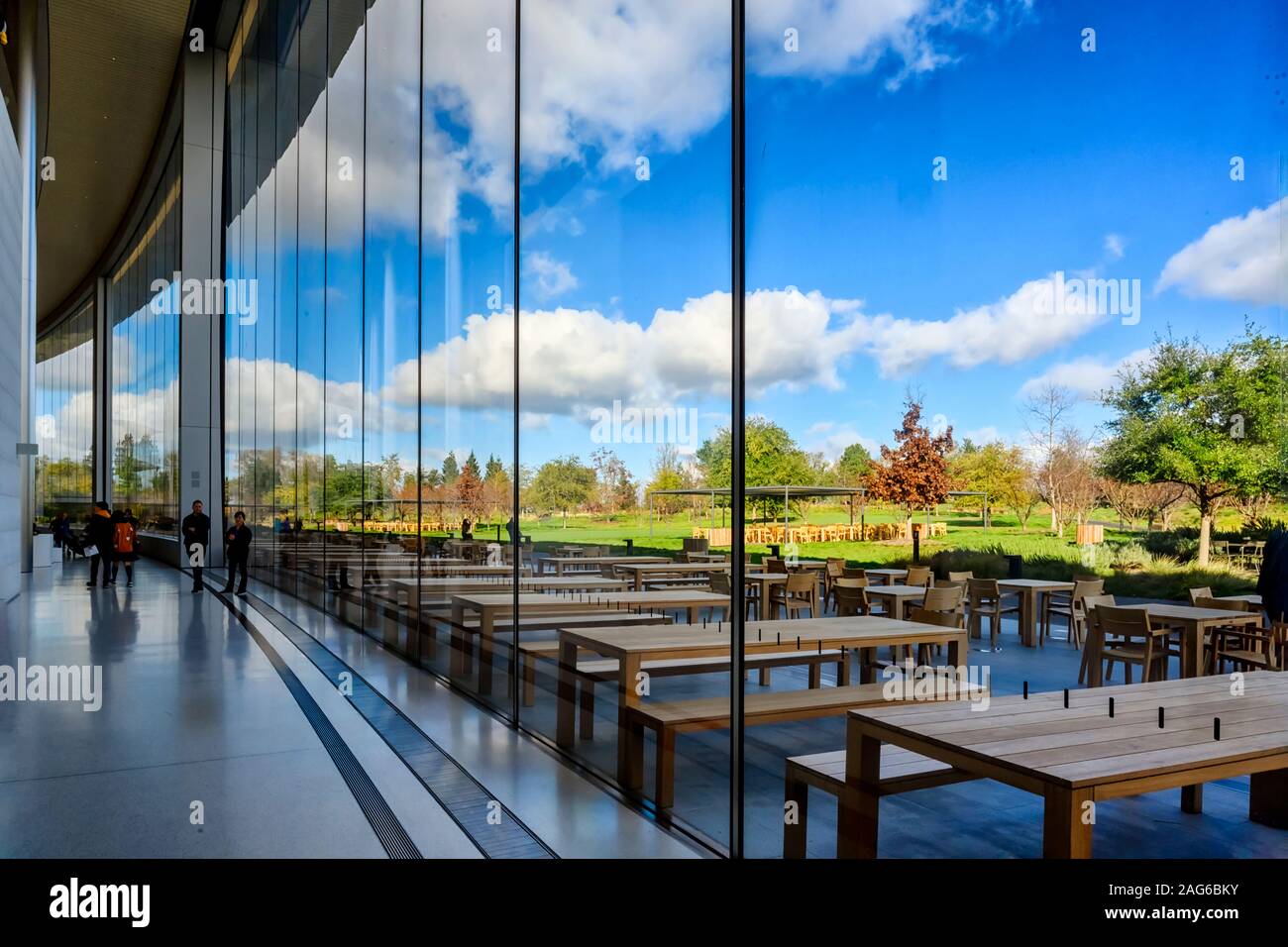Cupertino CA USA December 14, 2019: Apple headquarters offices building, looking through the glass window of the inside of the building to the inner c Stock Photo