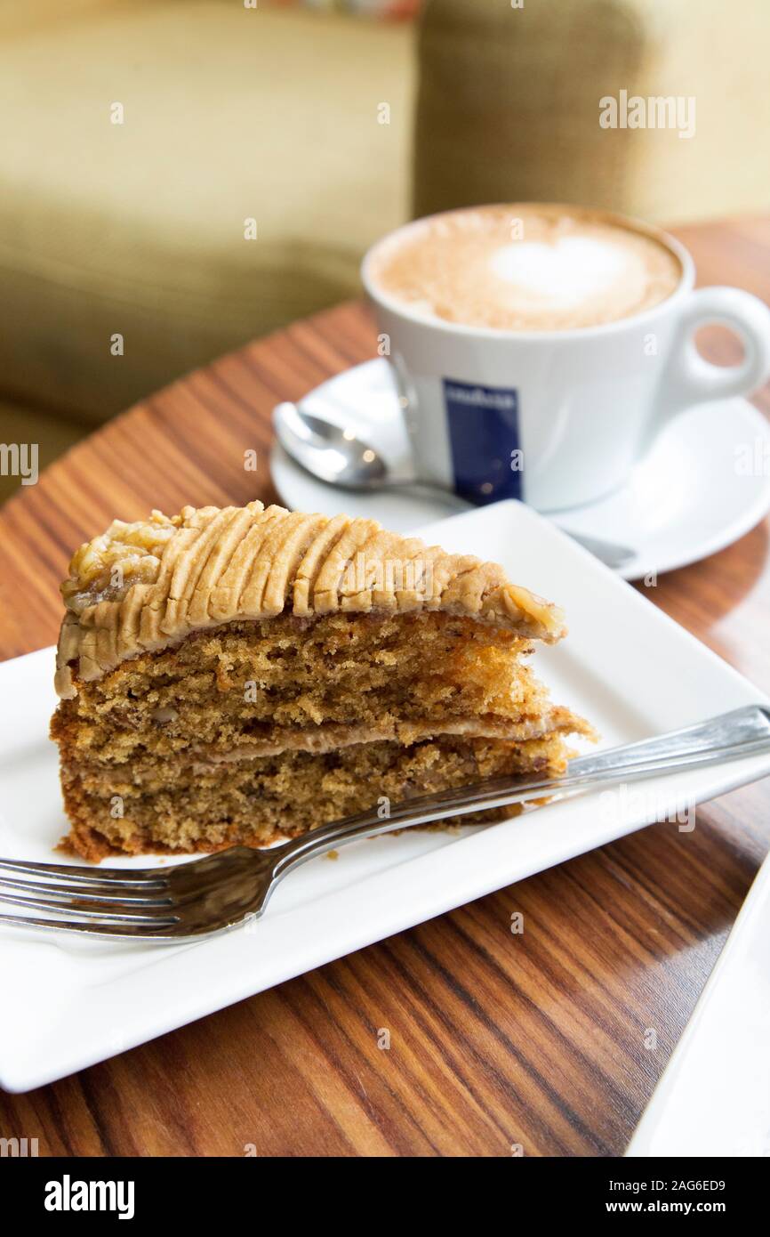 Close up of a cup of coffee and slice of cake. Stock Photo