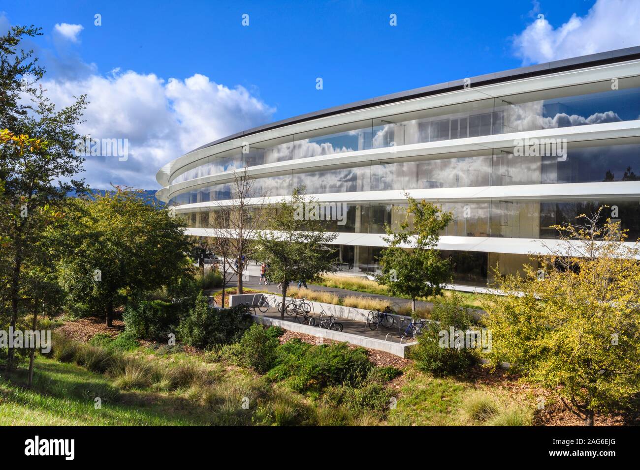 Cupertino CA USA December 14, 2019: Closeup of Apple headquarters offices building exterior with employee bicycles and drought tolerant native landsca Stock Photo