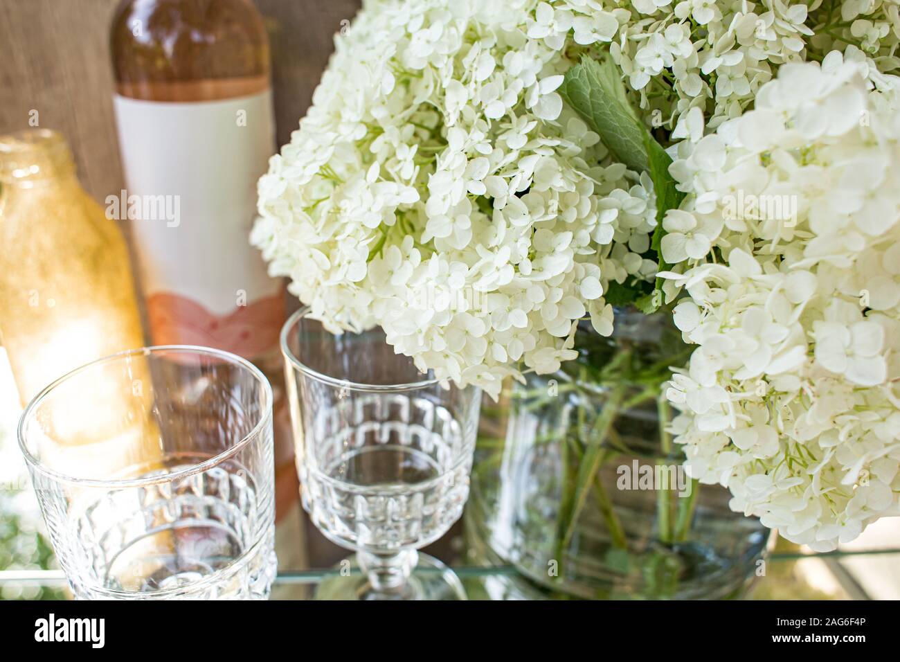 Rose blush wine in glasses. Bottle of rose wine with flowers on