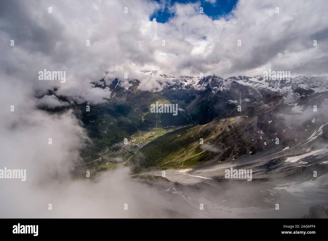 Aerial view of the small town, surrounding mountains covered in snow ...