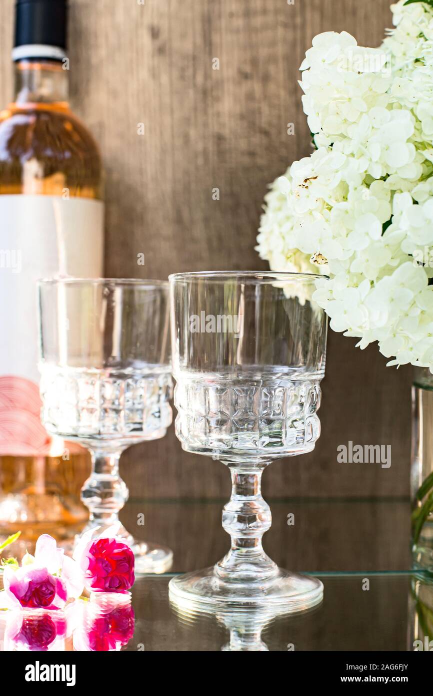 Rose blush wine in glasses. Bottle of rose wine with flowers on