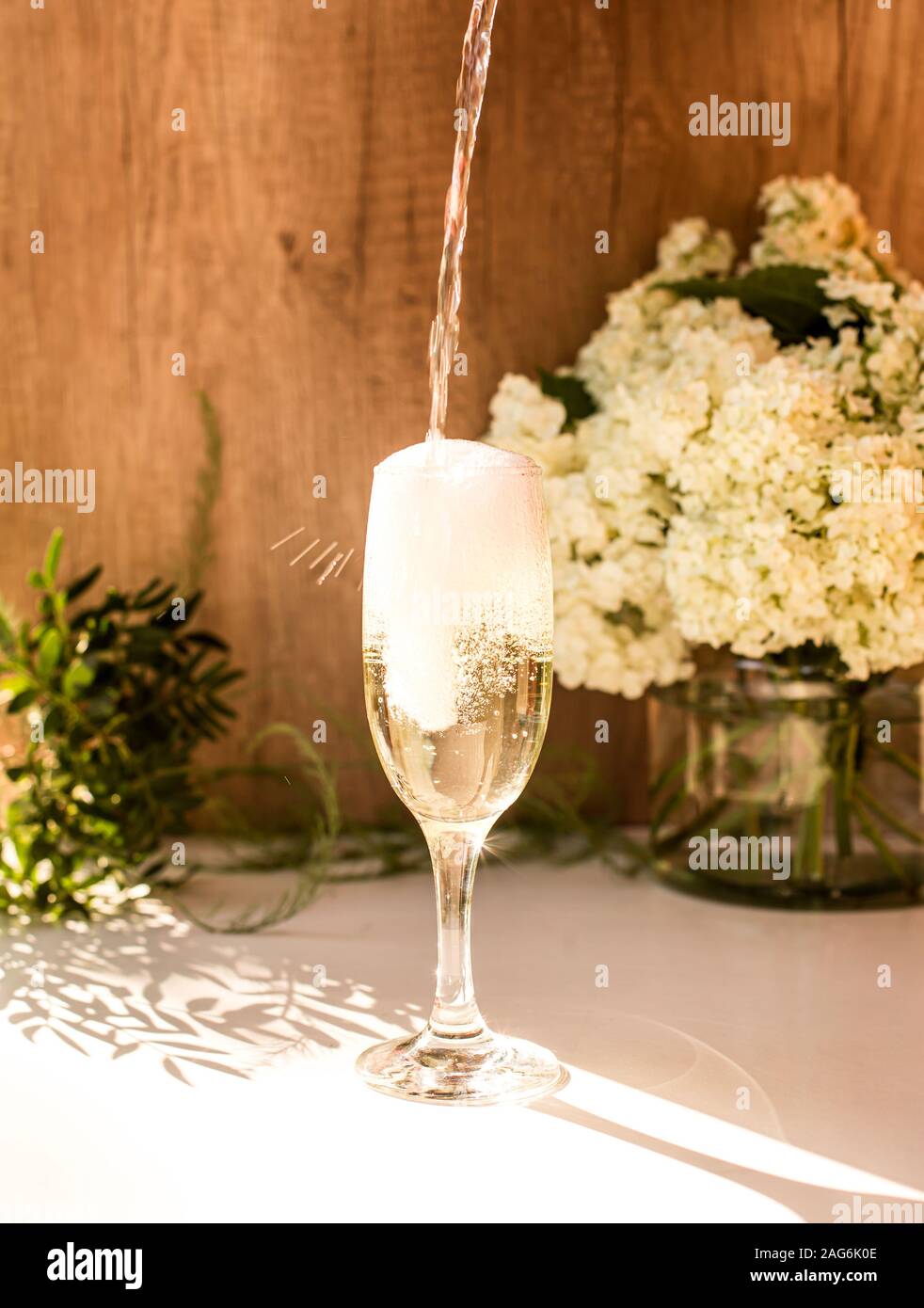 Rose blush wine in glasses. Bottle of rose wine with flowers on background. Prosecco Stock Photo