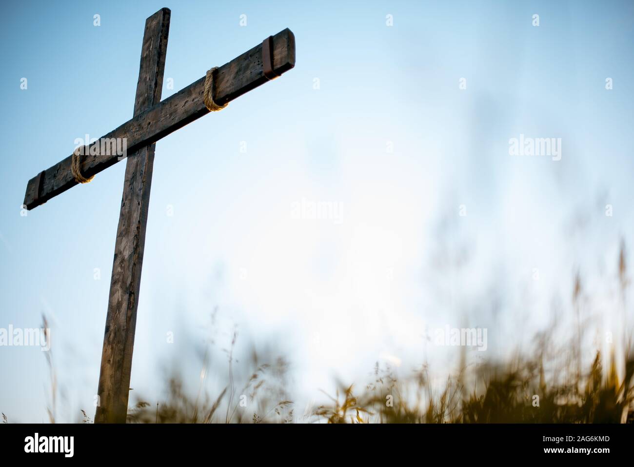 A Low Angle Shot Of A Handmade Wooden Cross In A Grassy Field With