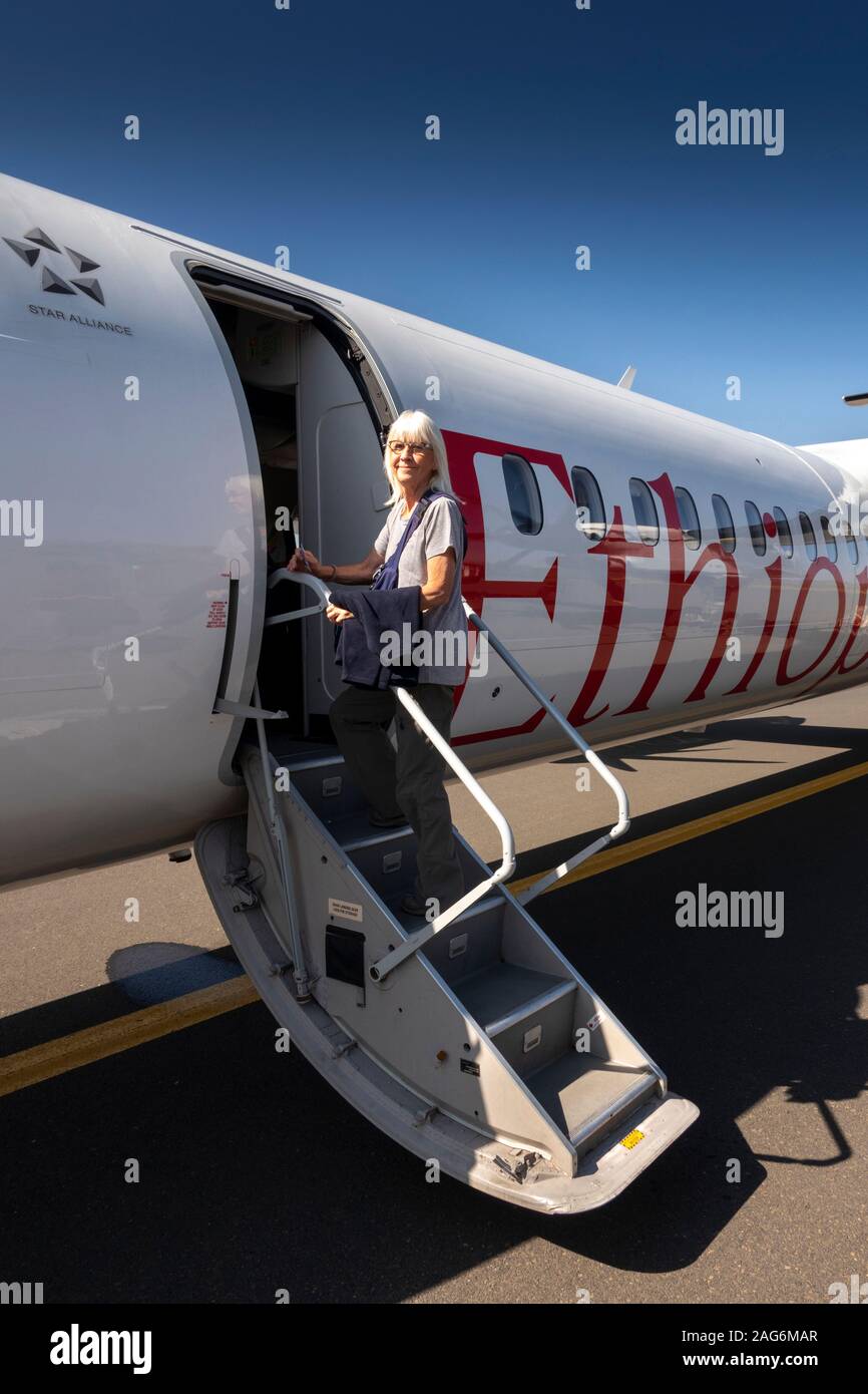 Ethiopia, Amhara, Lalibela, Airport, senior female tourist boarding Ethiopian Airlines Bombardier Q400, Dash 8 aircraft Stock Photo