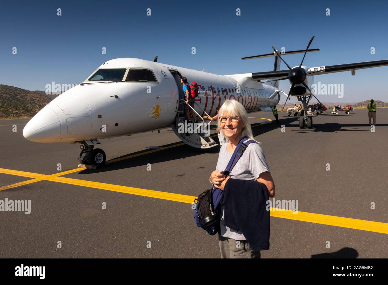 Ethiopia, Amhara, Lalibela, Airport, senior female tourist about to board Ethiopian Airlines Bombardier Q400, Dash 8 aircraft Stock Photo