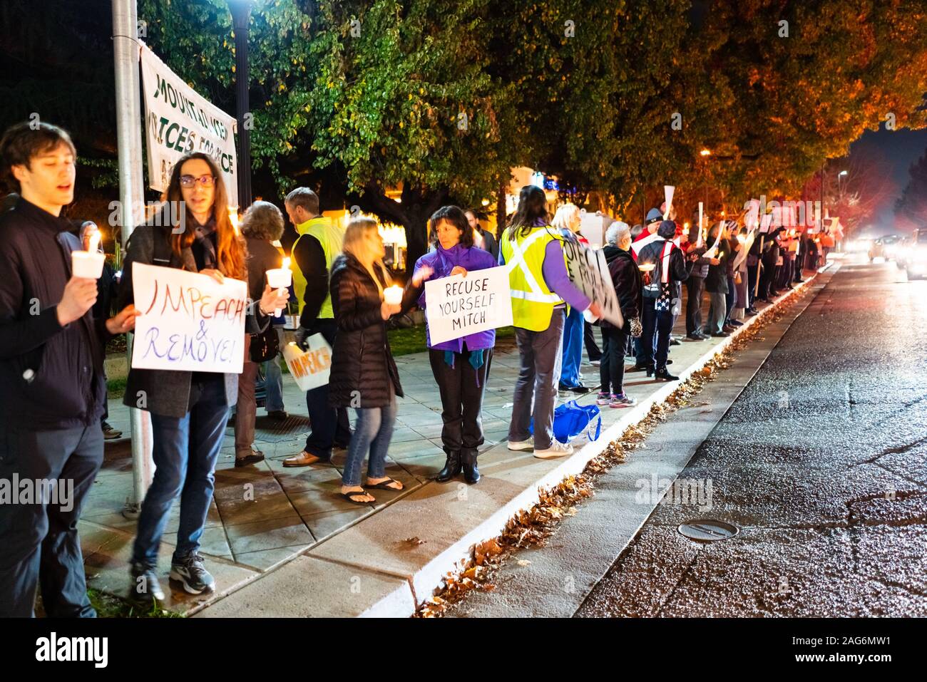 Dec 17, 2019 Mountain View / CA / USA - Protesters carrying signs at the Impeachment Eve Vigil rally held in one of the cities of San Francisco Bay; Stock Photo