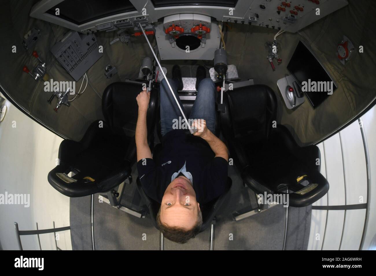 10 December 2019, North Rhine-Westphalia, Cologne: Astronaut Matthias Maurer sits in a training module of a Soyuz capsule at the European Astronaut Centre (EAC) on the ESA premises. Photo: Felix Hörhager/dpa Stock Photo