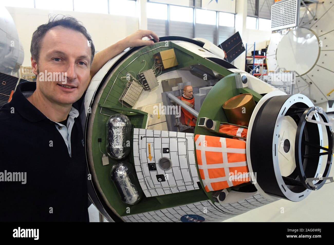 Cologne, Germany. 10th Dec, 2019. Astronaut Matthias Maurer stands next to a model of the Orion space capsule at the European Astronaut Centre (EAC) on ESA premises. Credit: Felix Hörhager/dpa/Alamy Live News Stock Photo