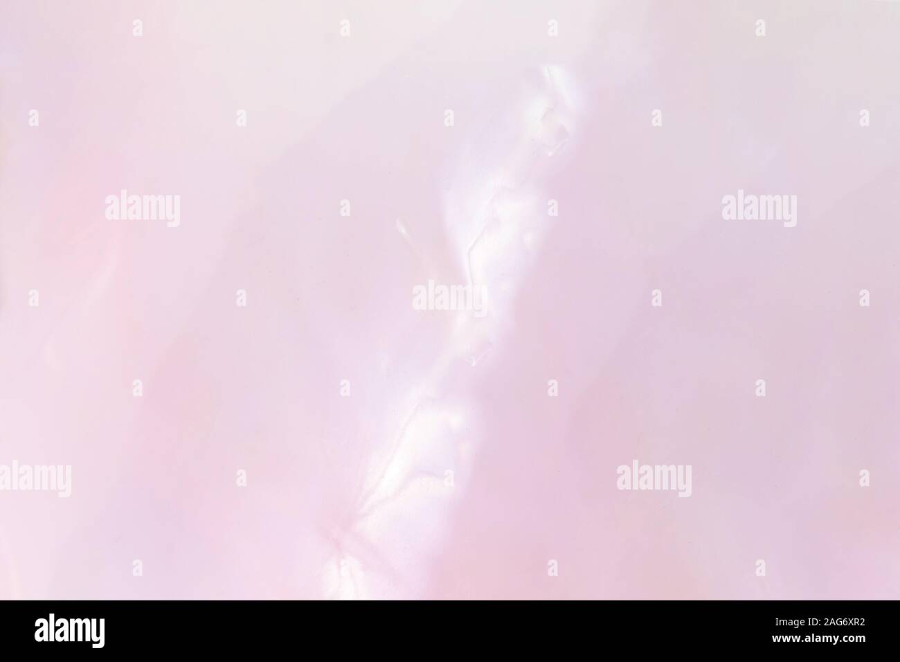 Abstract soft shiny layer or rose nacre. Amazing mauve mother of pearl background. Abalone shimmering. Stock Photo