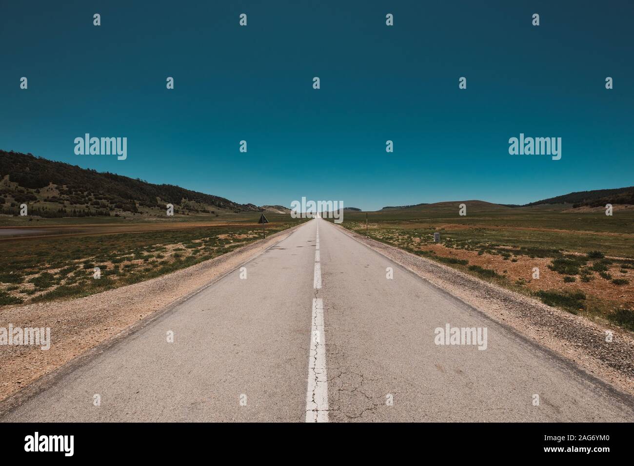 Magnificent view of an endless road under the clear blue sky captured in Morocco Stock Photo