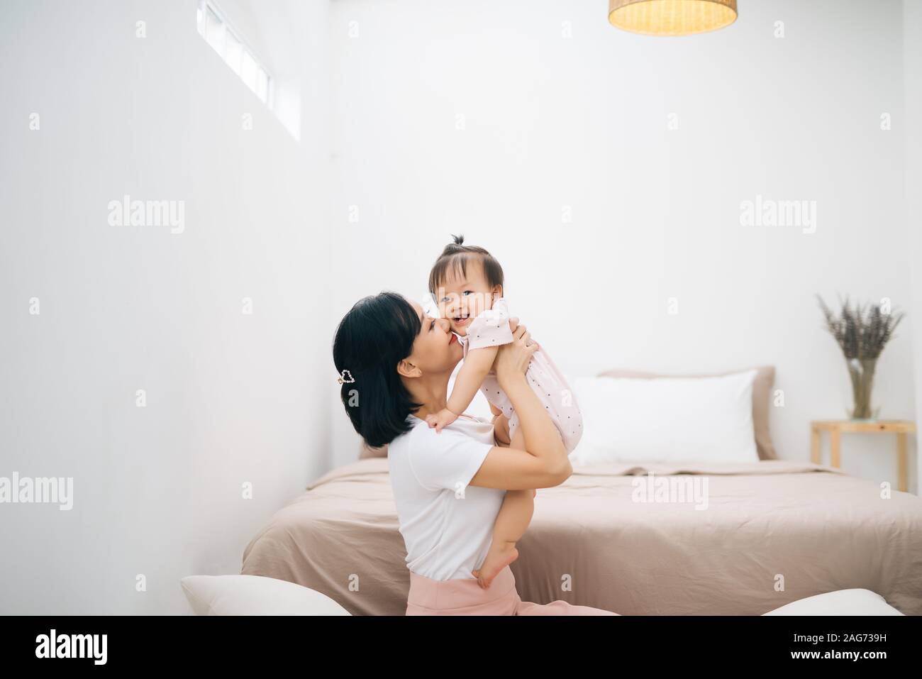 asian mother and child relaxing on the bed room Stock Photo