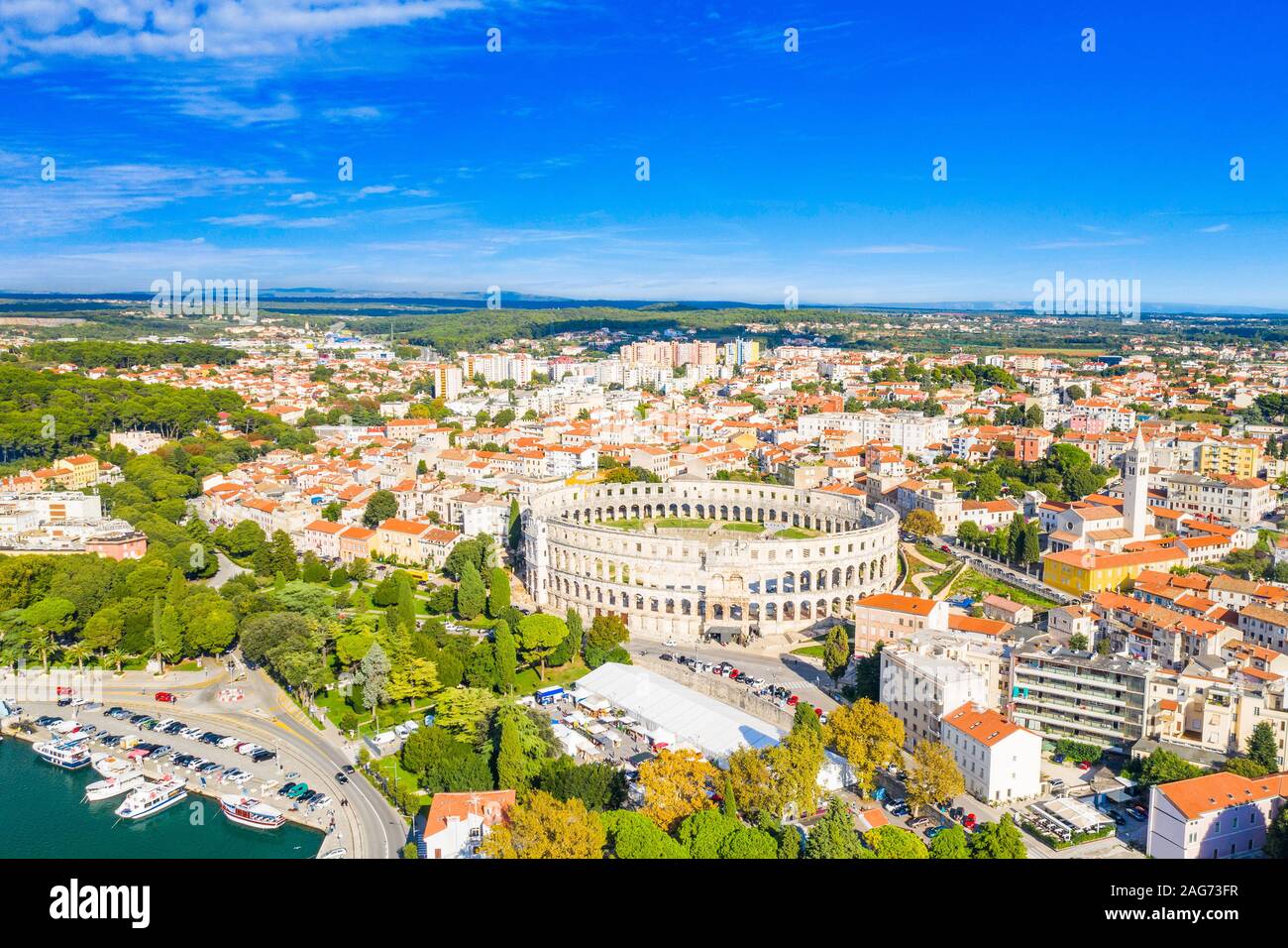 Ancient Roman arena, historic amphitheater and old town center from drone, aerial view, city of Pula, Adriatic sea, Croatia Stock Photo