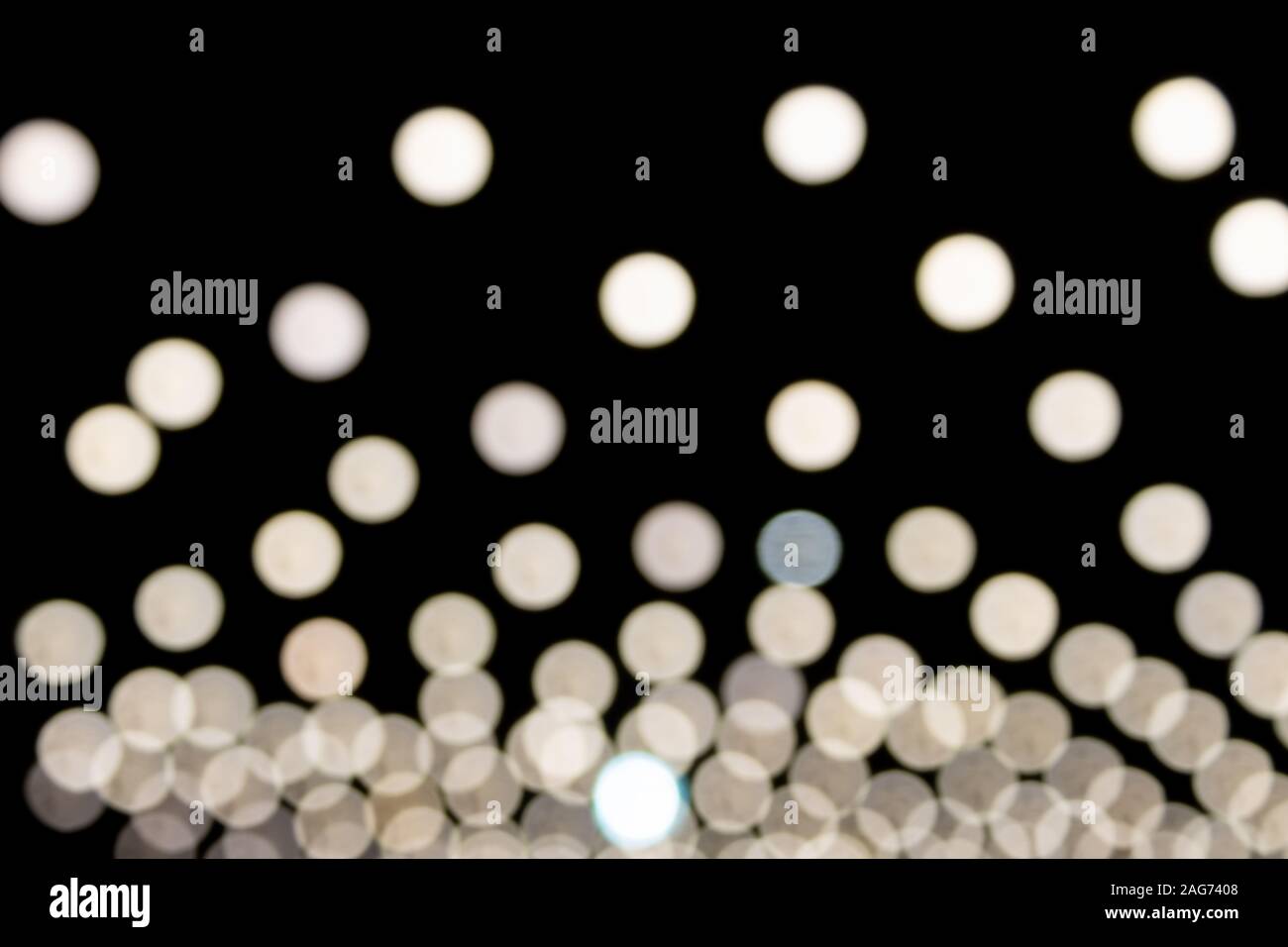 White Blurred Lights on Black Background in Center Frame Stock Photo