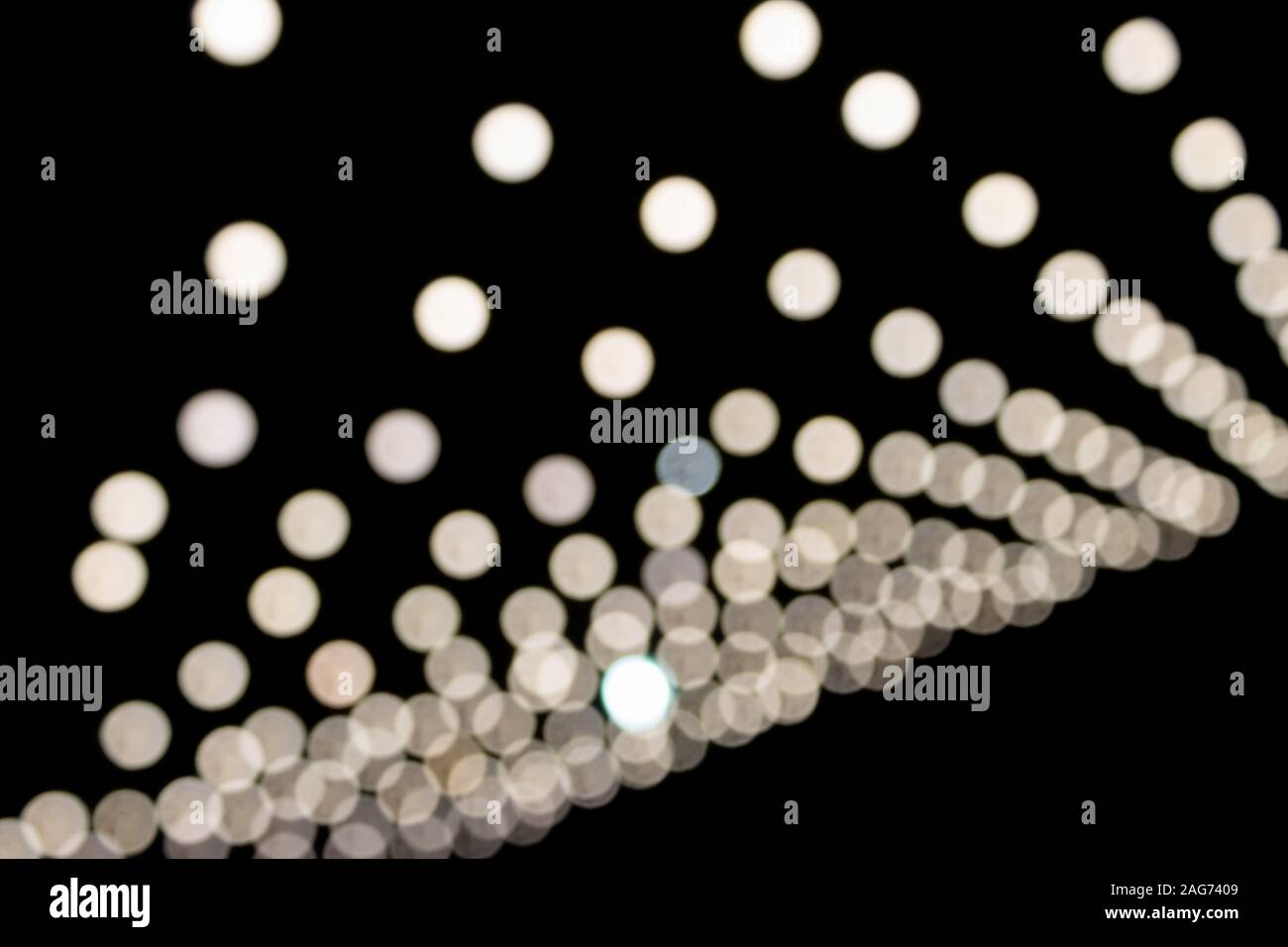 White Blurred Lights on Black Background. Stock Photo