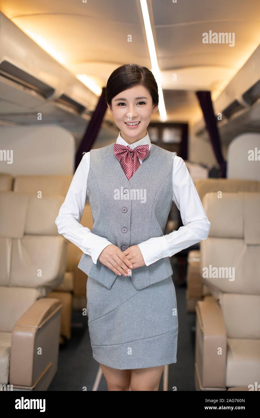 Portrait of smiling Chinese flight attendant Stock Photo - Alamy