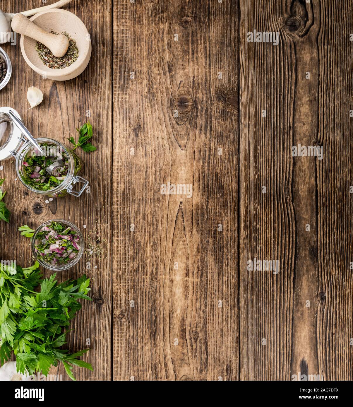 Healthy homemade Chimichurri on a wooden table as detailed close-up shot (selective focus) Stock Photo