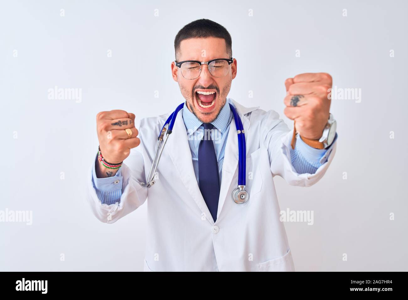 Young doctor man wearing stethoscope over isolated background angry and ...
