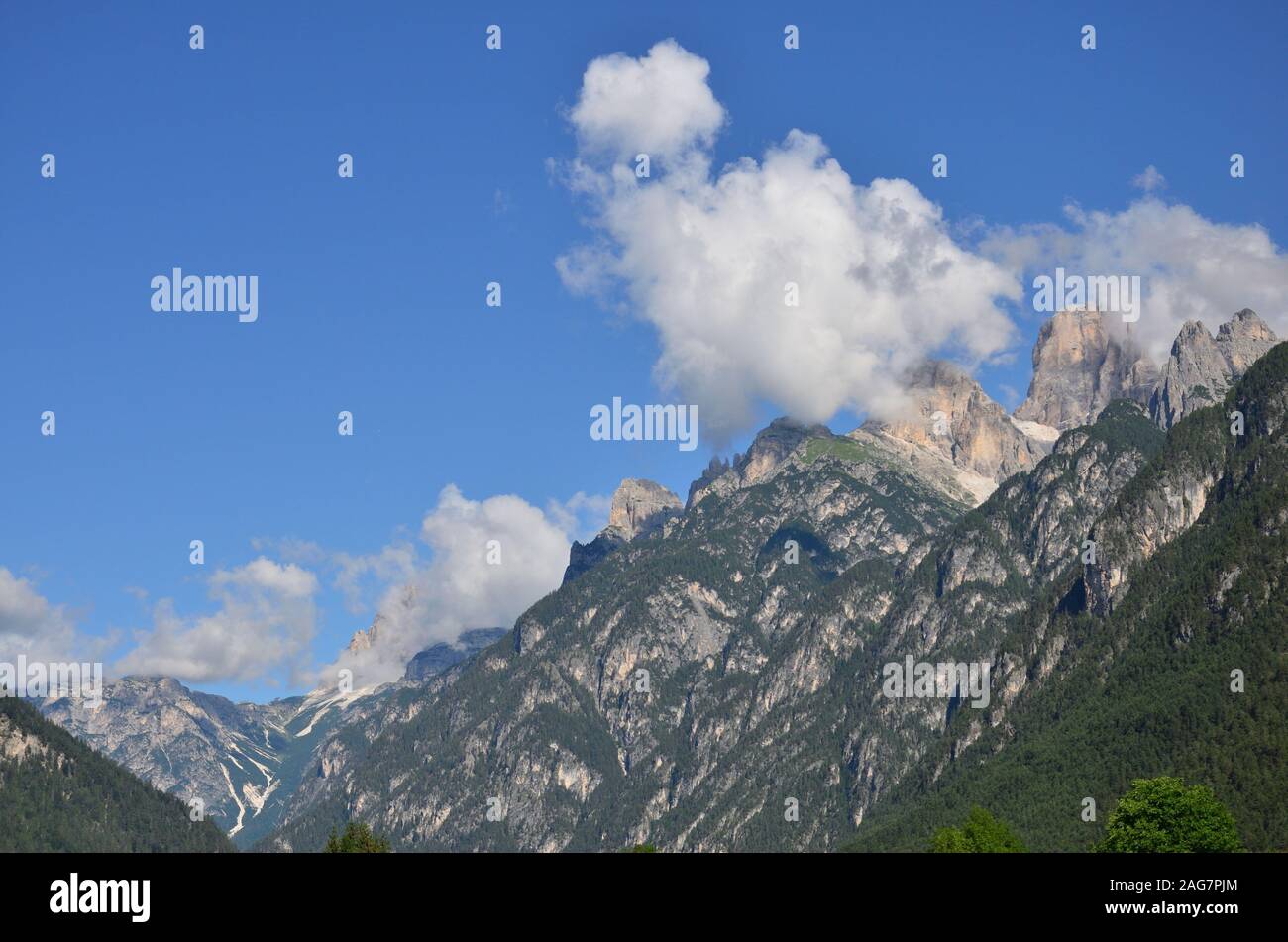 Clouds on the peaks of the Dolomites on a summer day Stock Photo - Alamy