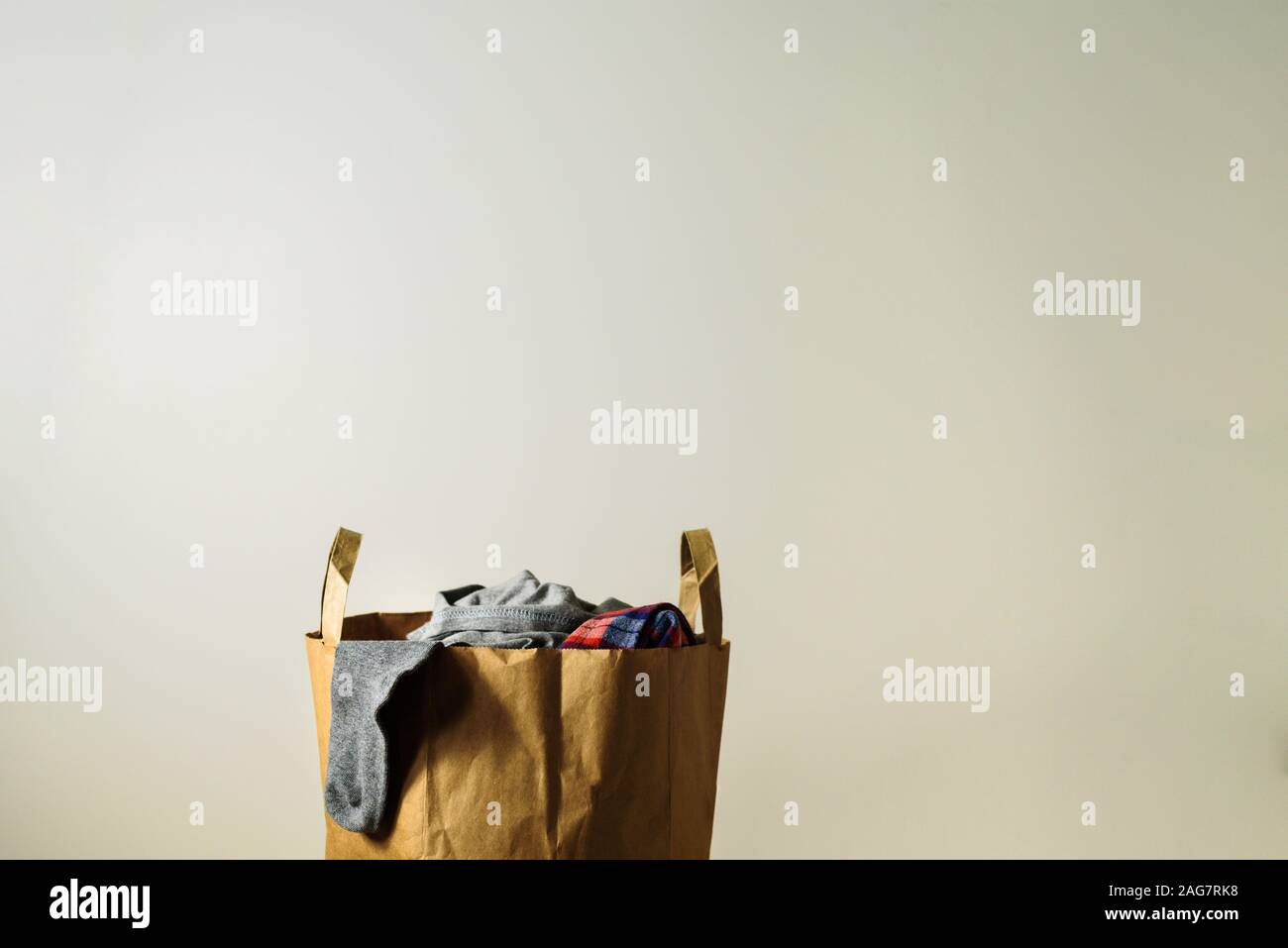 Paper bag with used clothes donation. Reuse concept Stock Photo Alamy