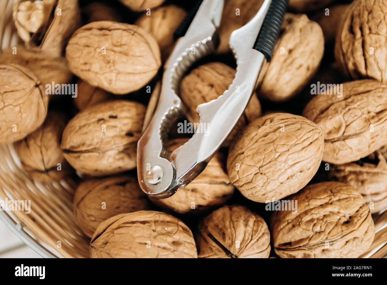 Nutcracker and walnuts in a large bowl Stock Photo