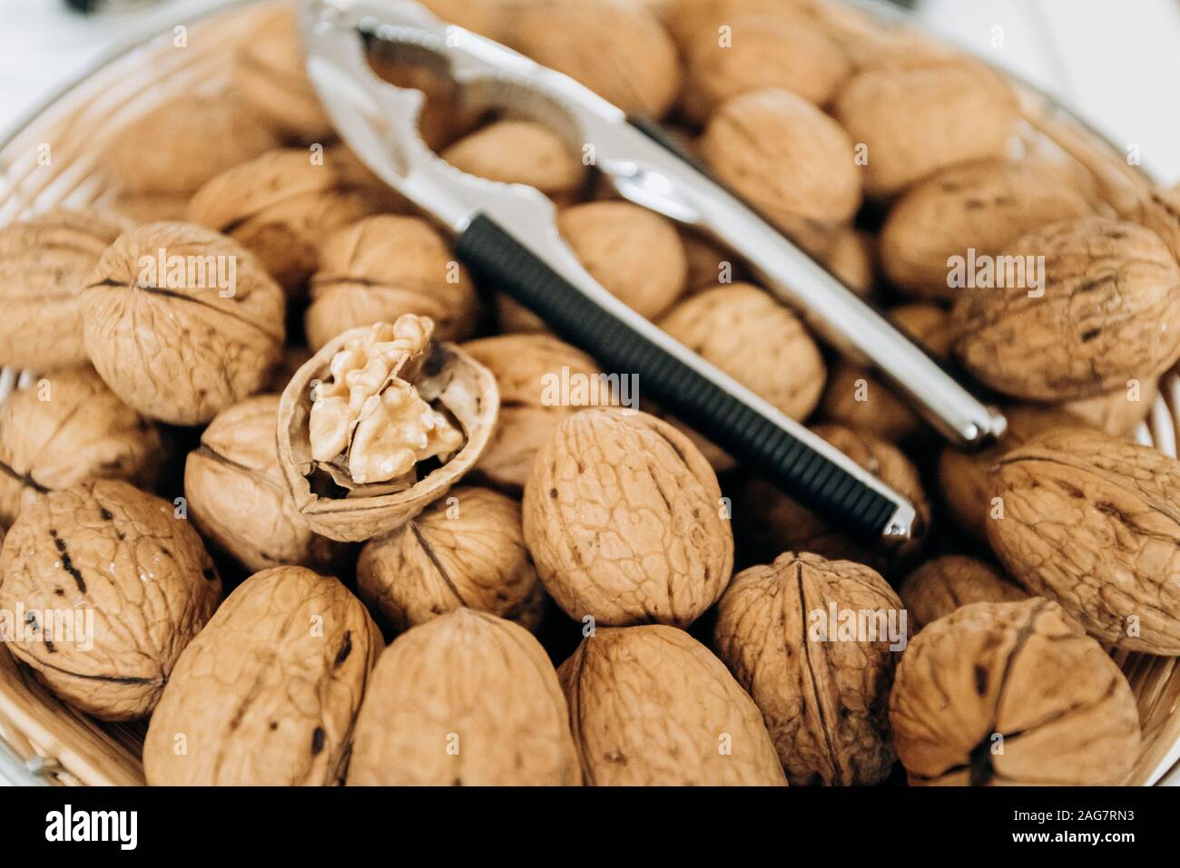 Nutcracker and walnuts in a large bowl Stock Photo
