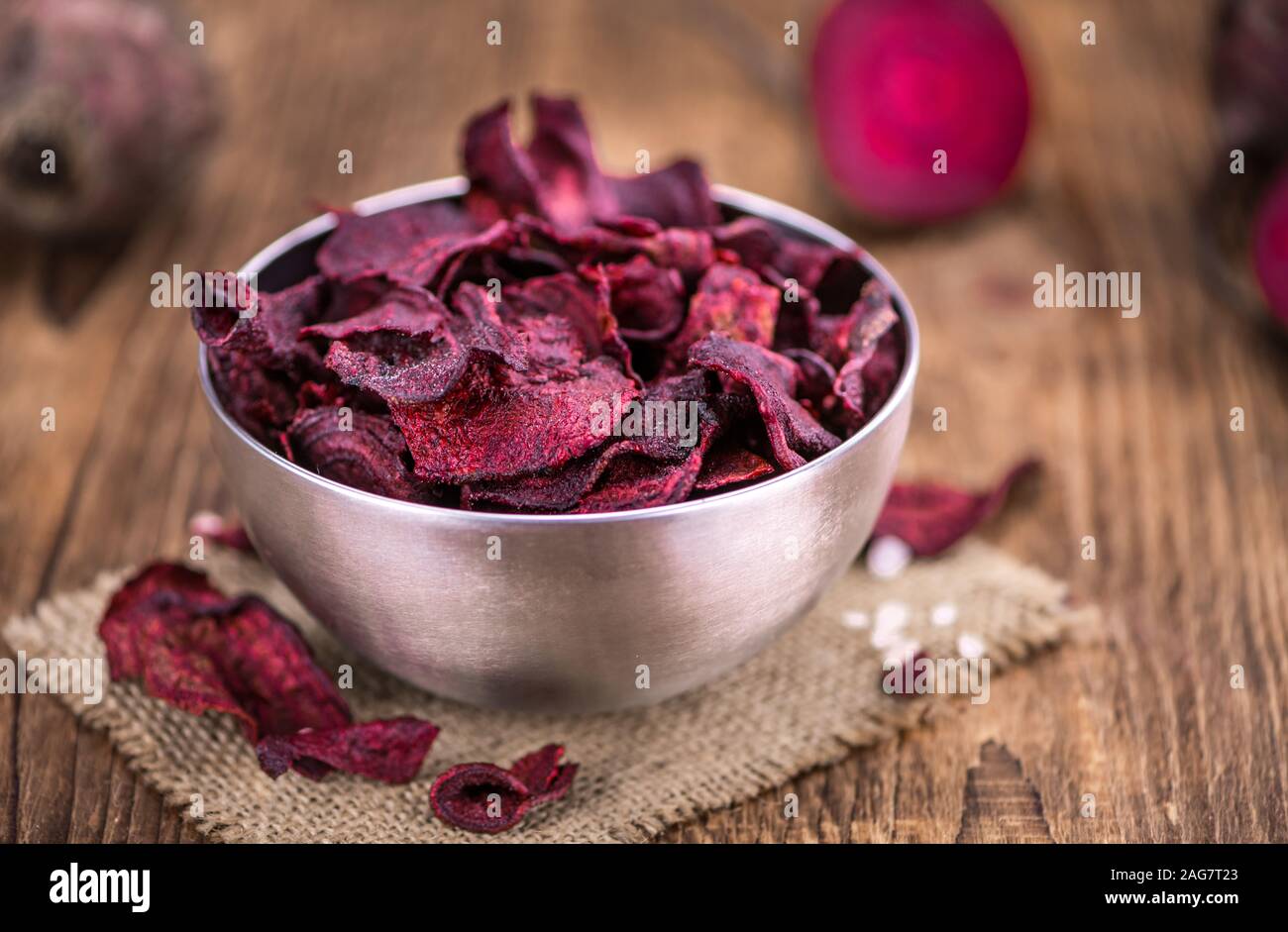 Some fresh Beetroot Chips on wooden background (selective focus; close-up shot) Stock Photo